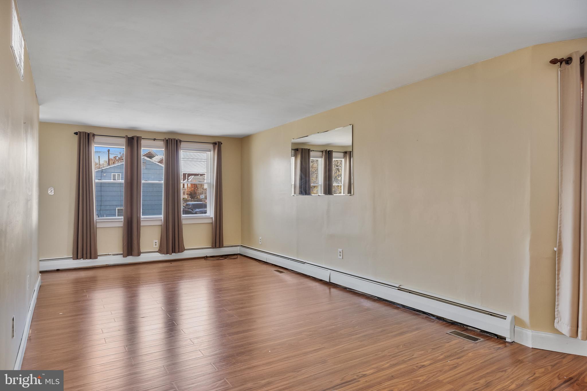 19 South Chestnut Avenue Maple Shade, NJ 08052 - Photo 8 of 31 a view of an empty room with wooden floor and a window