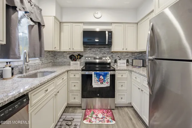 a kitchen with a refrigerator and a sink