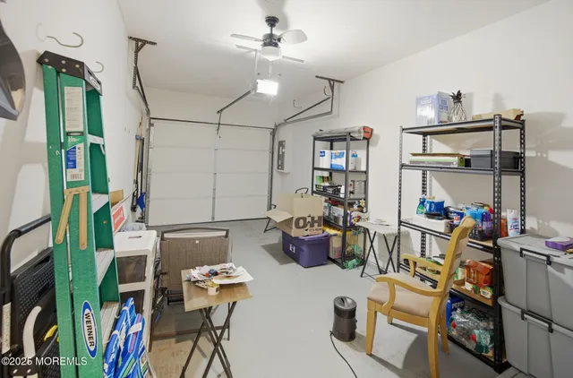 a patio with table and chairs and potted plants