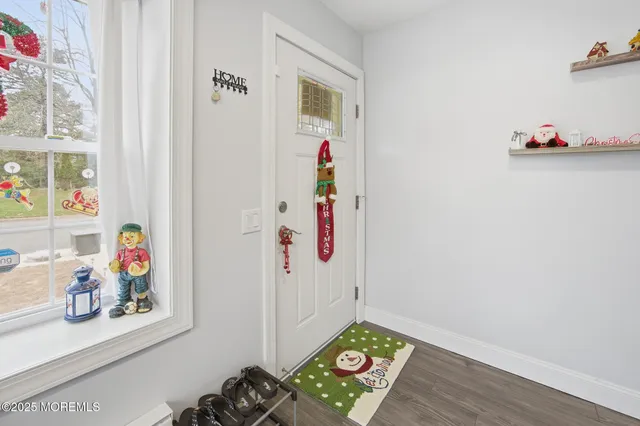 a view of living room with furniture and wooden floor