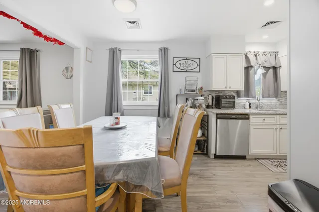 a kitchen with stainless steel appliances granite countertop a stove top oven a sink and a refrigerator