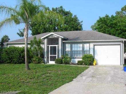 18538 Violet Road Fort Myers, FL 33967 - Photo 1 of 13 a front view of a house with garden
