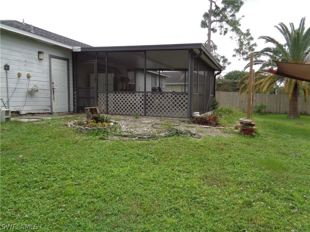 18538 Violet Road Fort Myers, FL 33967 - Photo 12 of 13 a backyard of a house with table and chairs