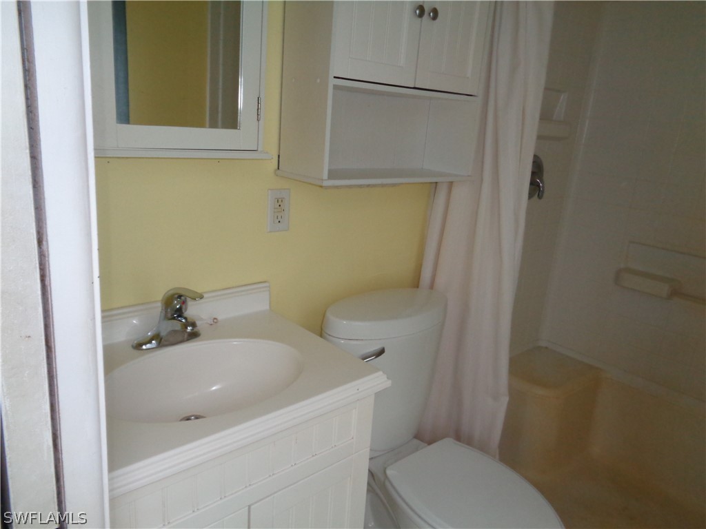 18538 Violet Road Fort Myers, FL 33967 - Photo 7 of 13 a bathroom with a sink a toilet and shower