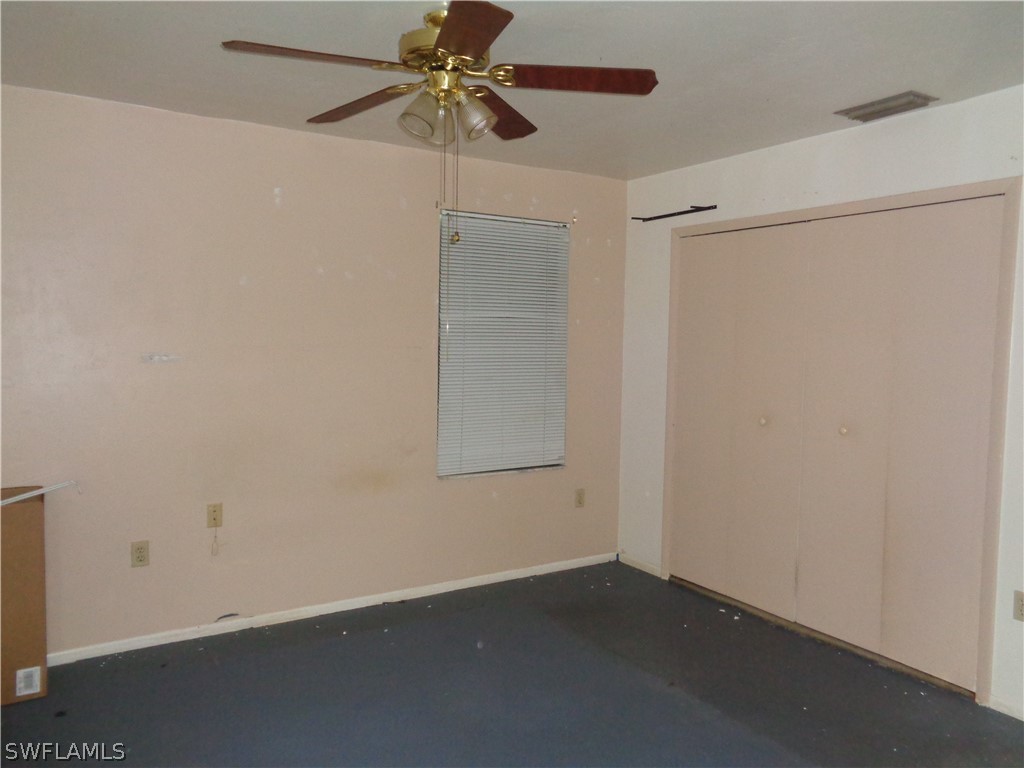 18538 Violet Road Fort Myers, FL 33967 - Photo 8 of 13 an empty room with a ceiling fan and a window