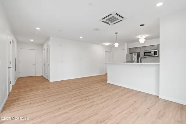 a view of a kitchen with a sink and a refrigerator