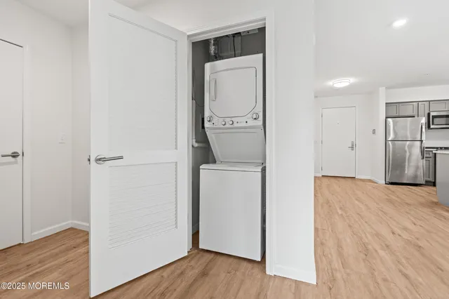 a view of a storage & utility room with a washer dryer