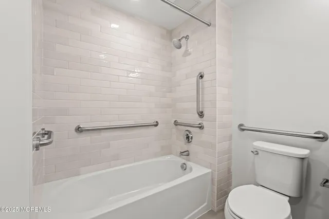 a bathroom with a toilet and a bath tub