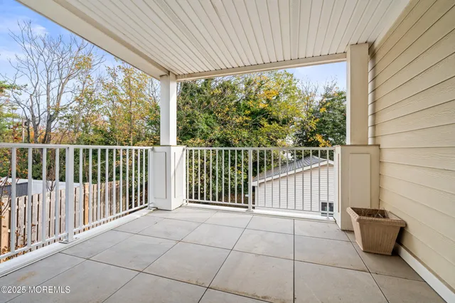 a view of a patio with a table and chairs