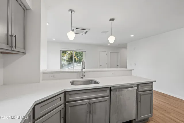 a kitchen with a sink cabinets and window
