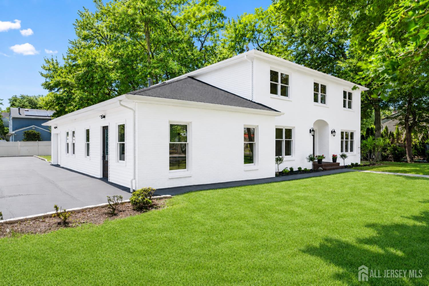 975 Inman Avenue Edison, NJ 08820 - Photo 4 of 61 a view of a white house with a yard and table