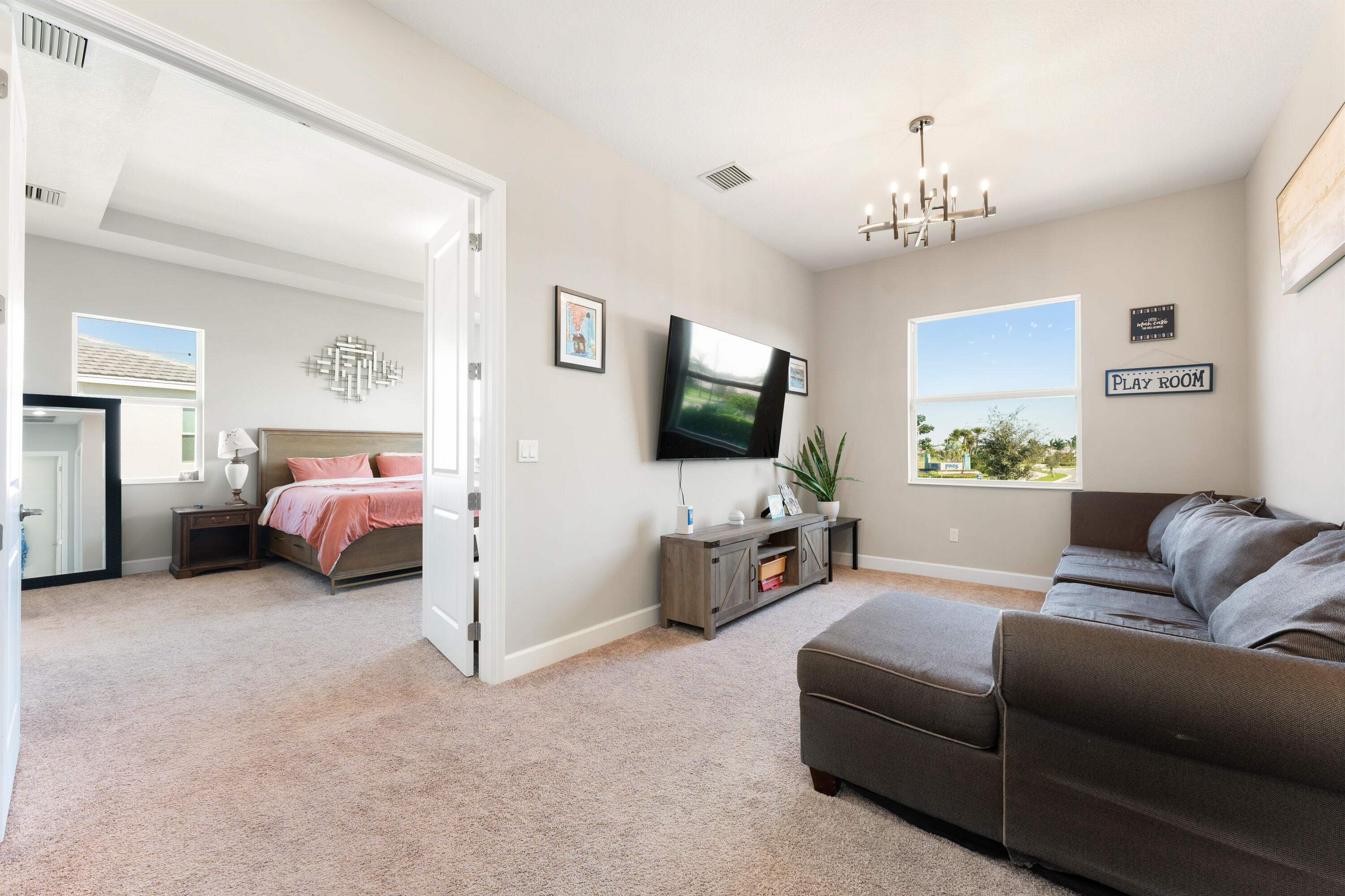 5446 Macoon Way Westlake, FL 33470 - Photo 11 of 40 a living room with furniture and a flat screen tv