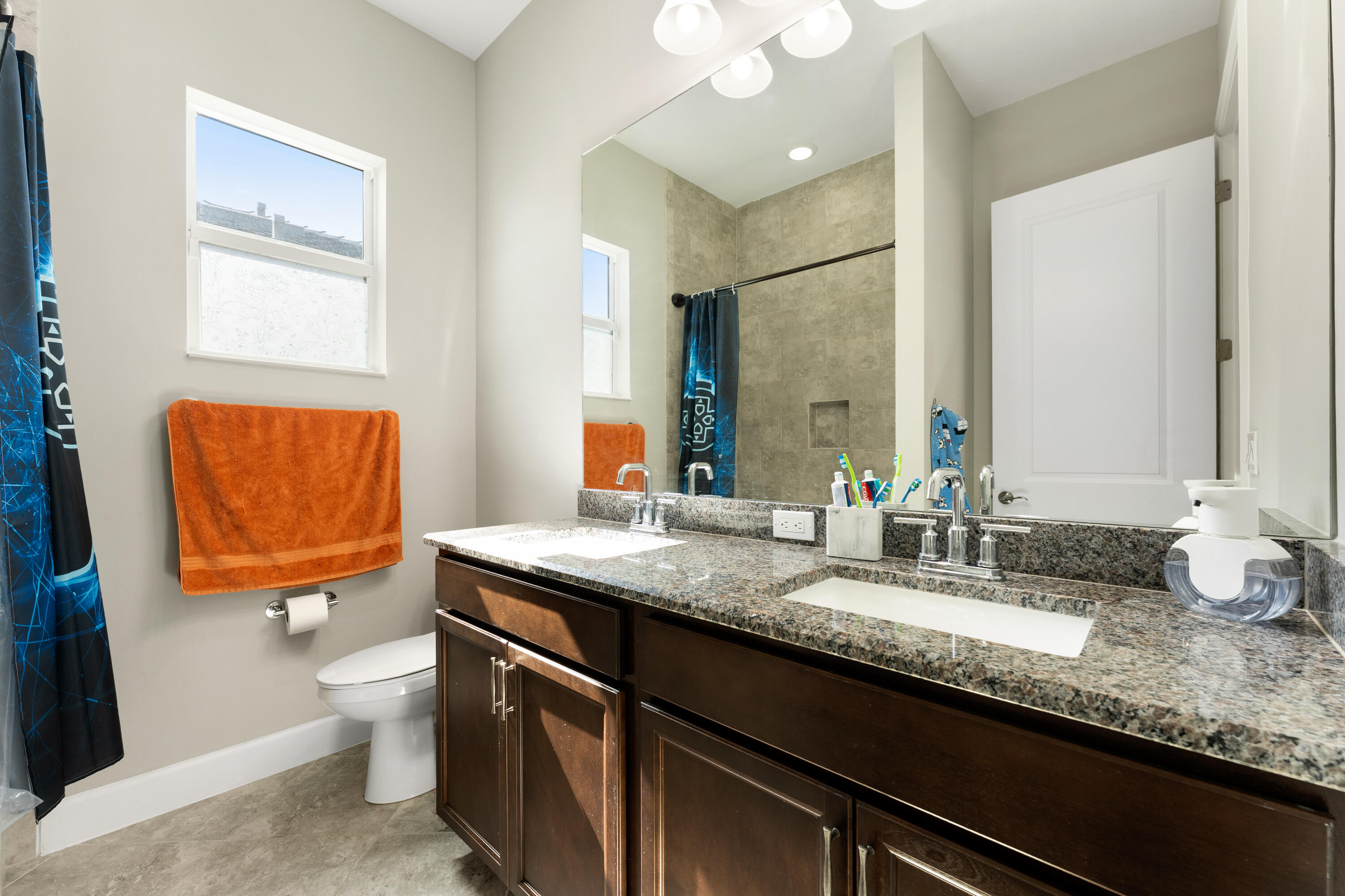 5446 Macoon Way Westlake, FL 33470 - Photo 21 of 40 a bathroom with a granite countertop sink a toilet and a mirror