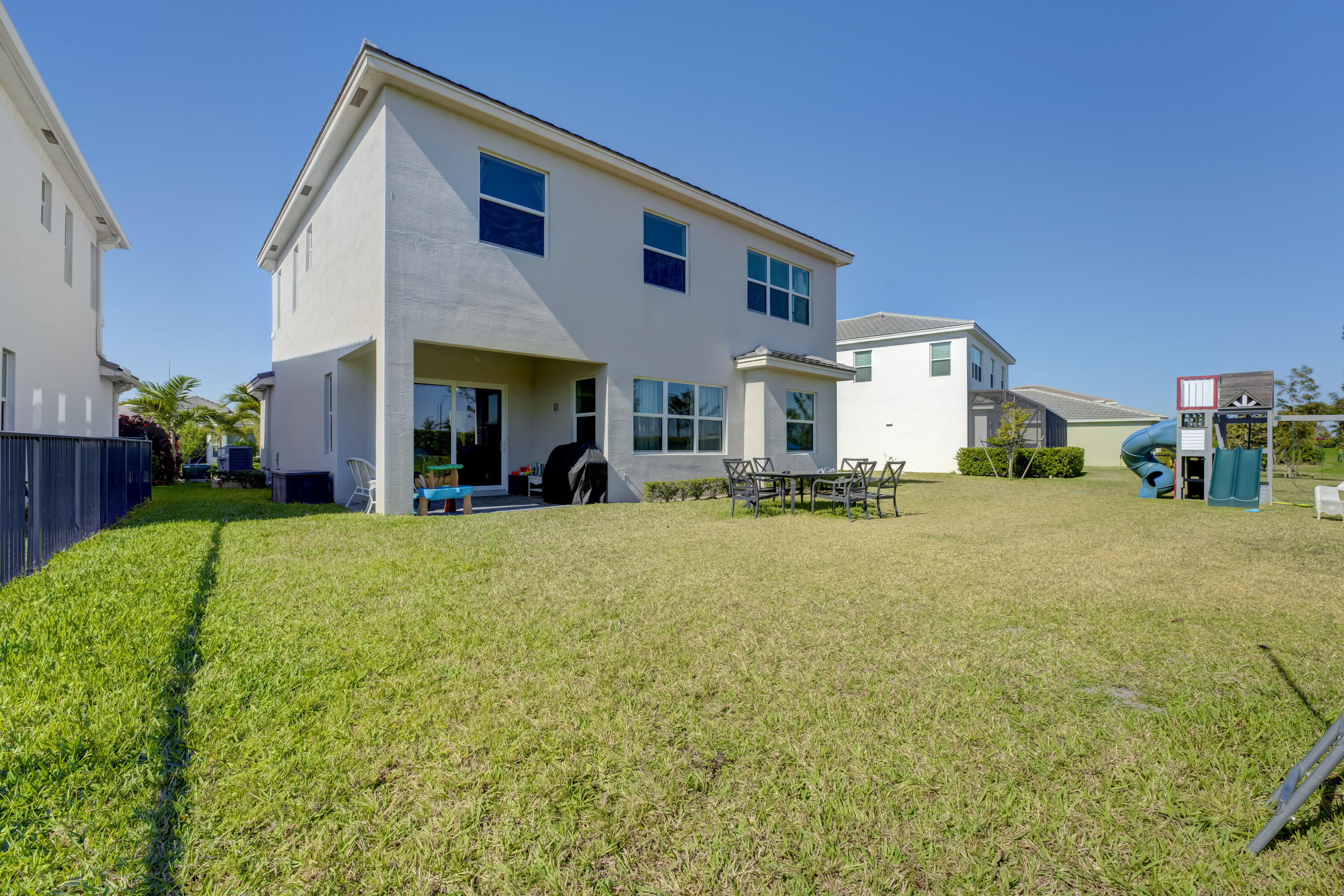 5446 Macoon Way Westlake, FL 33470 - Photo 27 of 40 a front view of building with yard