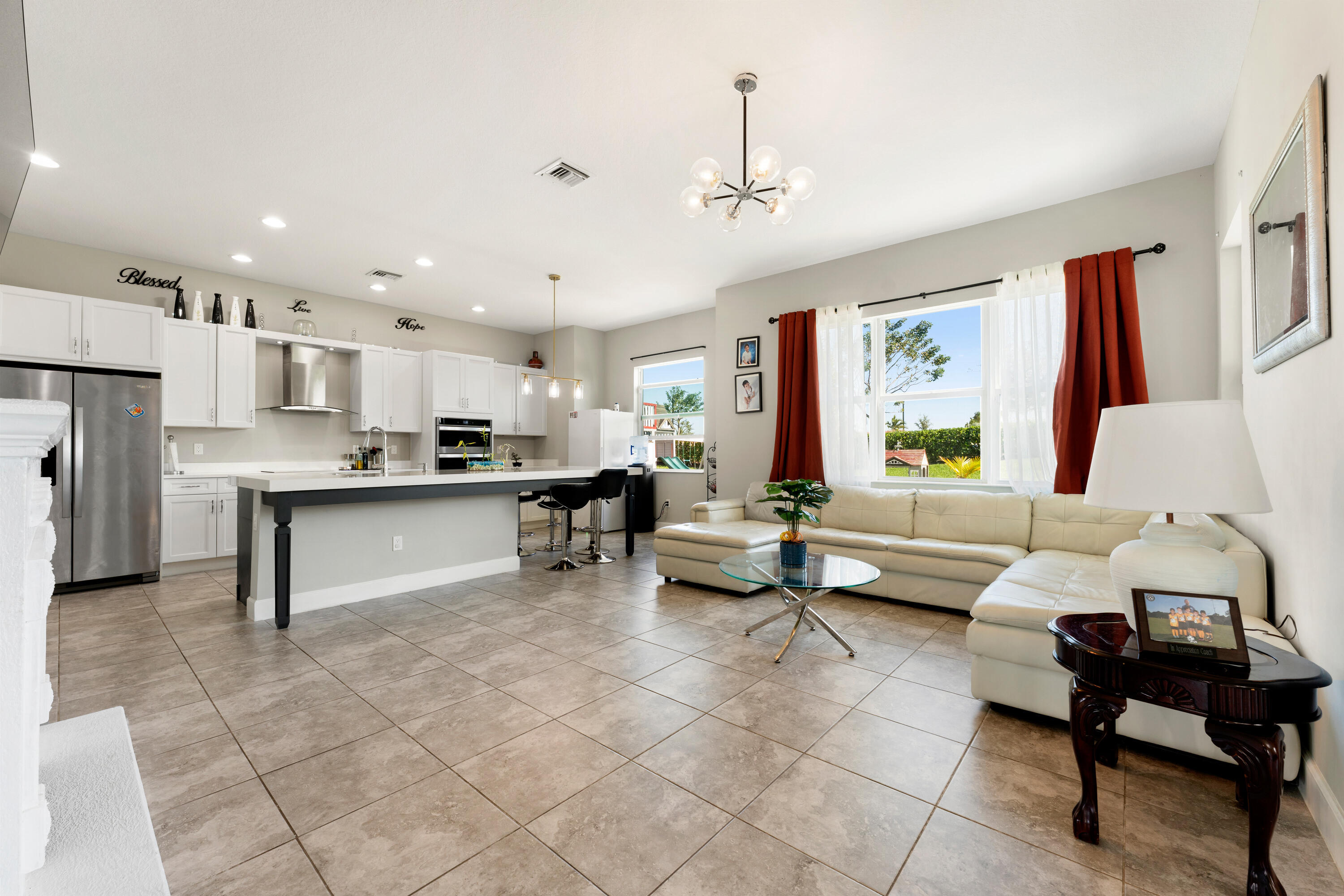 5446 Macoon Way Westlake, FL 33470 - Photo 3 of 40 a living room with furniture and kitchen view