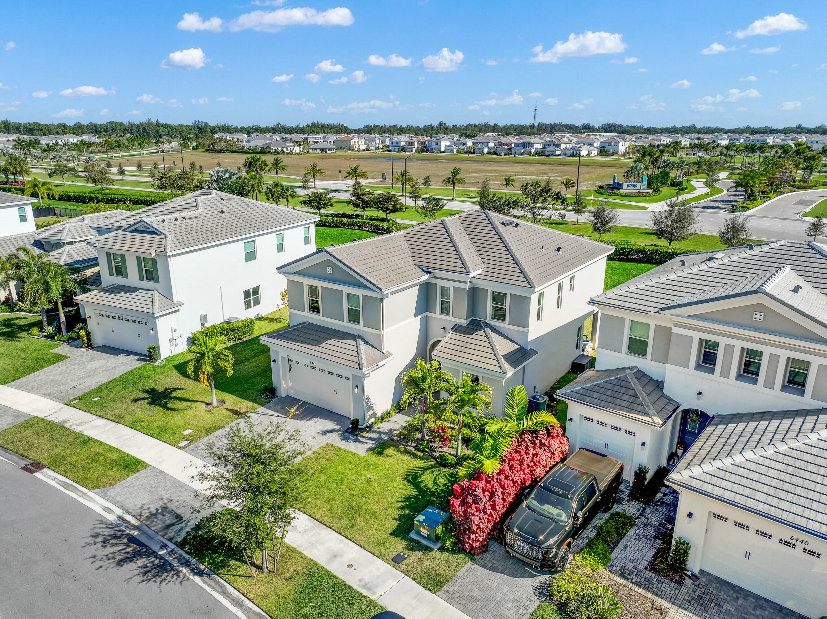 5446 Macoon Way Westlake, FL 33470 - Photo 34 of 40 an aerial view of a house with a garden and lake view