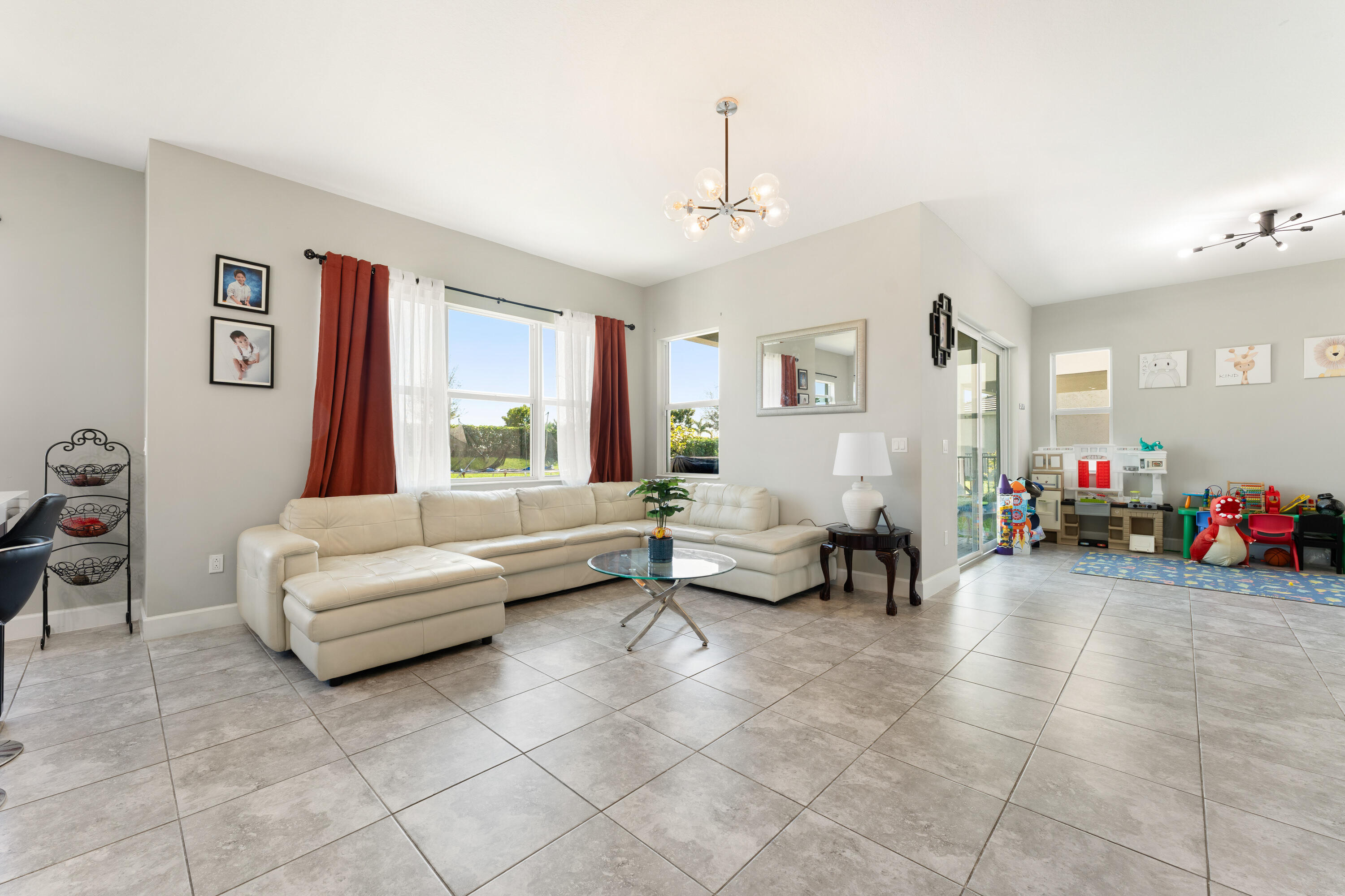 5446 Macoon Way Westlake, FL 33470 - Photo 4 of 40 a living room with furniture and a chandelier