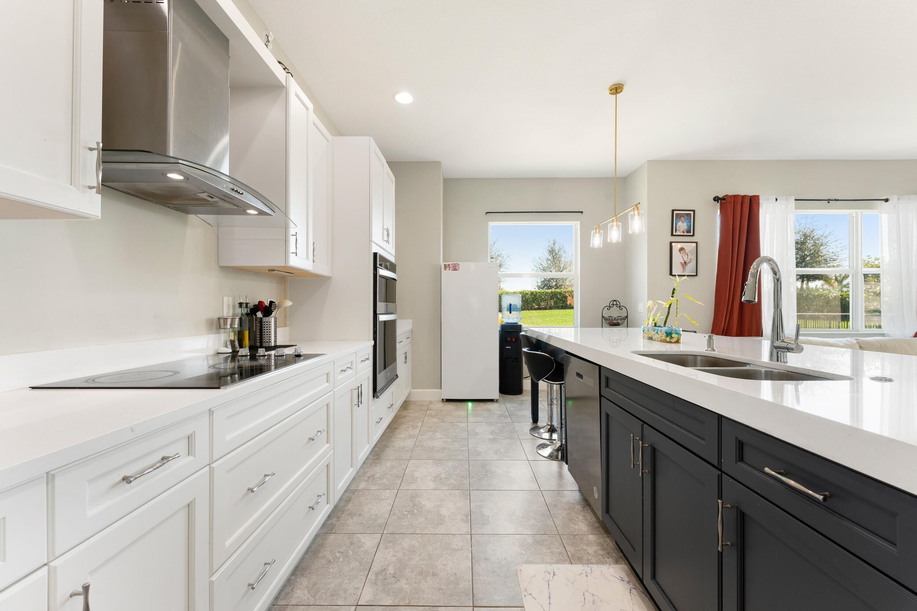5446 Macoon Way Westlake, FL 33470 - Photo 7 of 40 a large kitchen with stainless steel appliances kitchen island granite countertop a sink and cabinets
