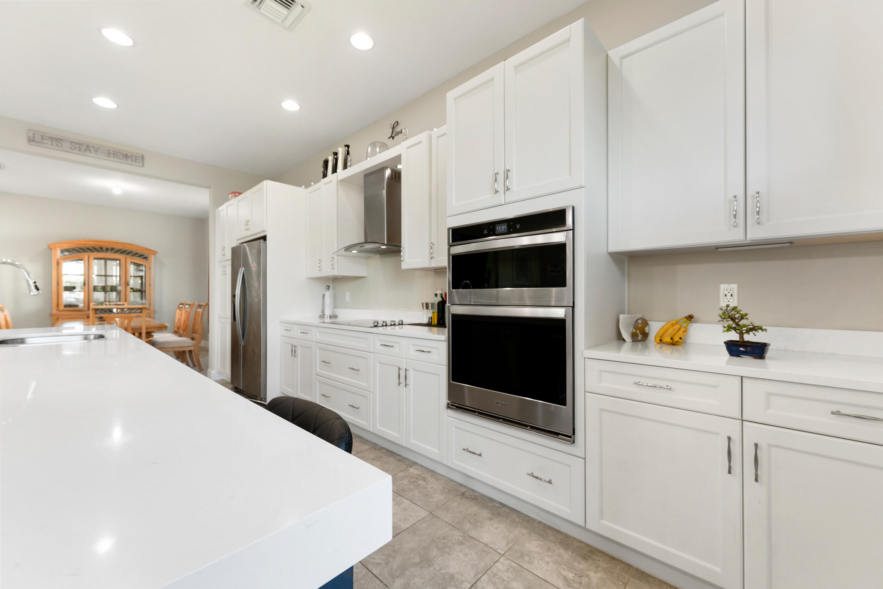 5446 Macoon Way Westlake, FL 33470 - Photo 8 of 40 a kitchen with stainless steel appliances a stove microwave and cabinets