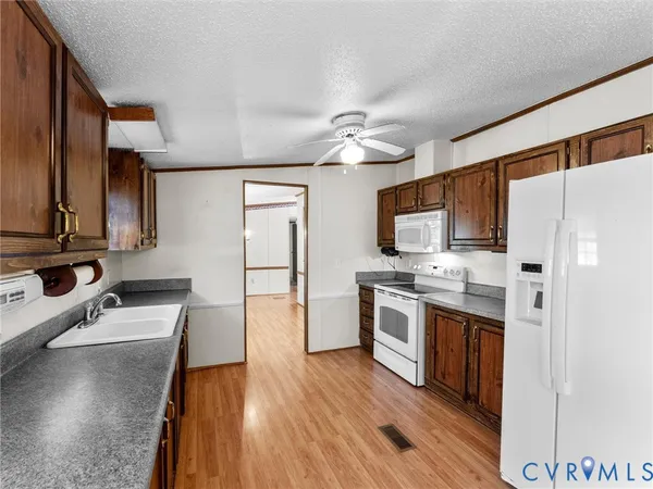 a kitchen with stainless steel appliances a stove refrigerator sink and microwave