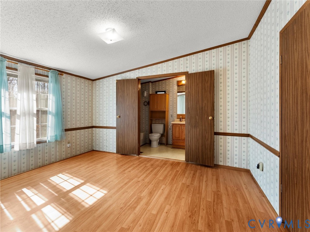 1349 Whispering Road Dillwyn, VA 23936 - Photo 28 of 51 a view of empty room with wooden floor and fan