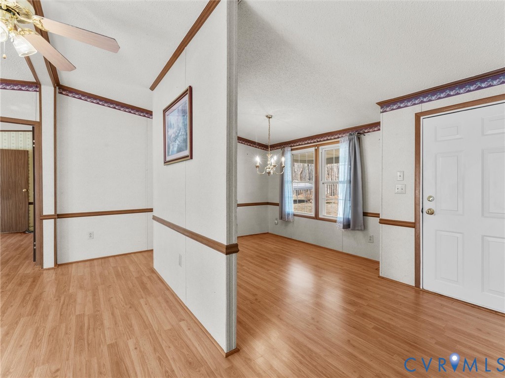 1349 Whispering Road Dillwyn, VA 23936 - Photo 8 of 51 a view of empty room with wooden floor and fan