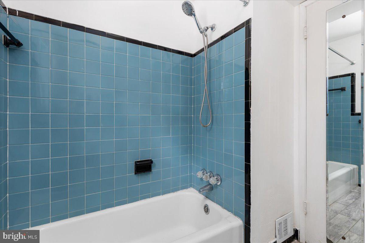 7410 Dickenson Street Springfield, VA 22150 - Photo 18 of 27 Charming blue-tiled bathroom retreat.