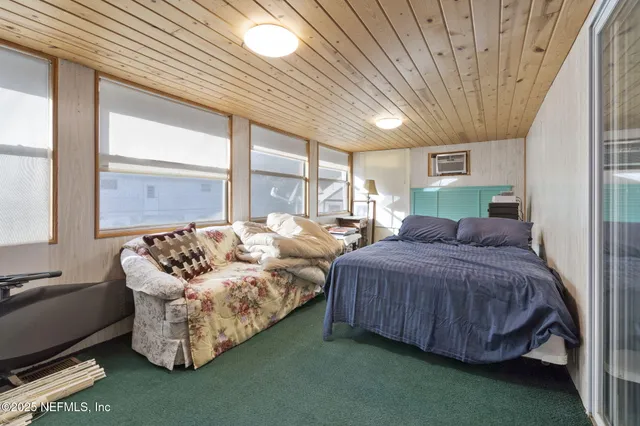 a spacious bedroom with bed and a large window