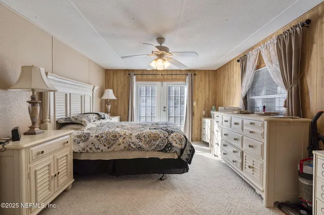 a spacious bedroom with a bed dresser and a window