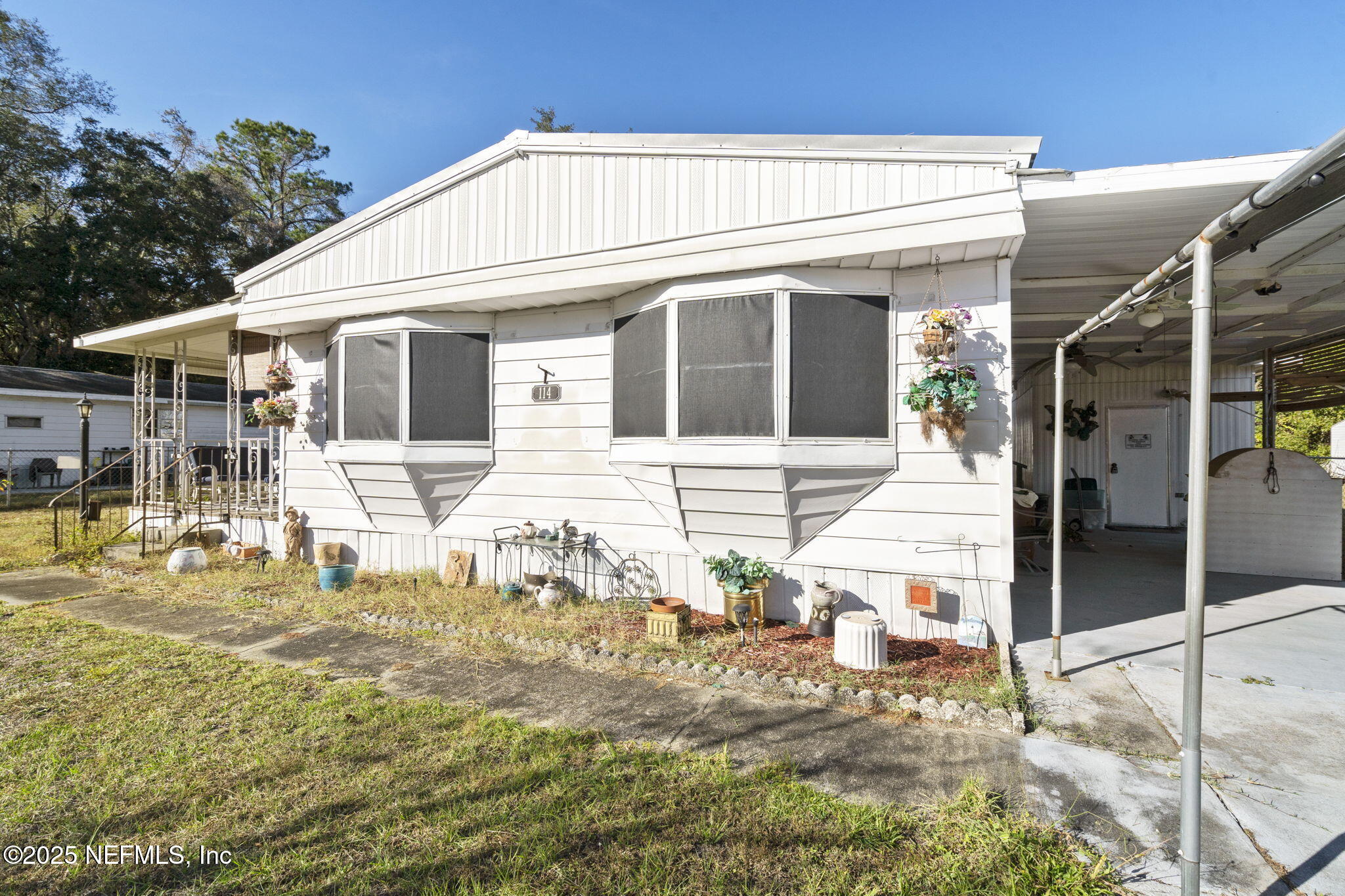 114 Sawyer Street Interlachen, FL 32148 - Photo 24 of 28 a view of a white house with large windows