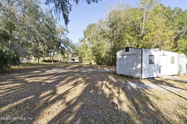 a view of a backyard of the house