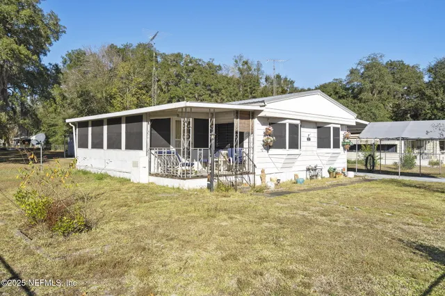 a view of a house with swimming pool and porch with furniture