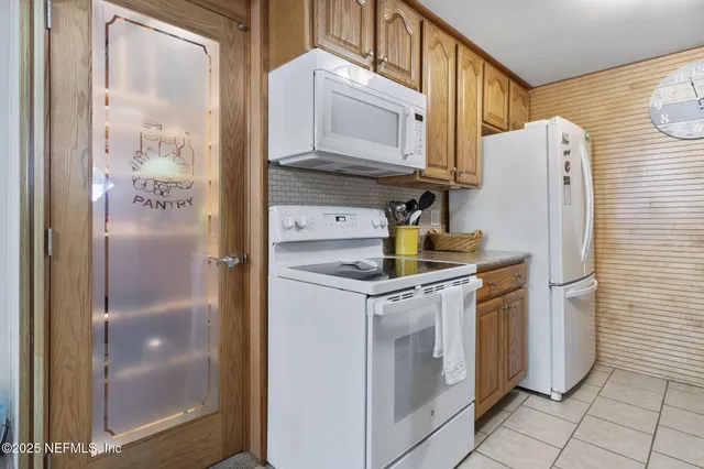 a kitchen with a refrigerator and cabinets