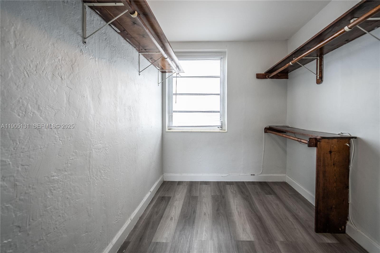 1208 71st Street, Unit 7 Miami Beach, FL 33141 - Photo 11 of 14 a view of a room with wooden floor and small window