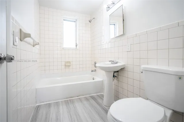 a bathroom with a sink a toilet and bathtub