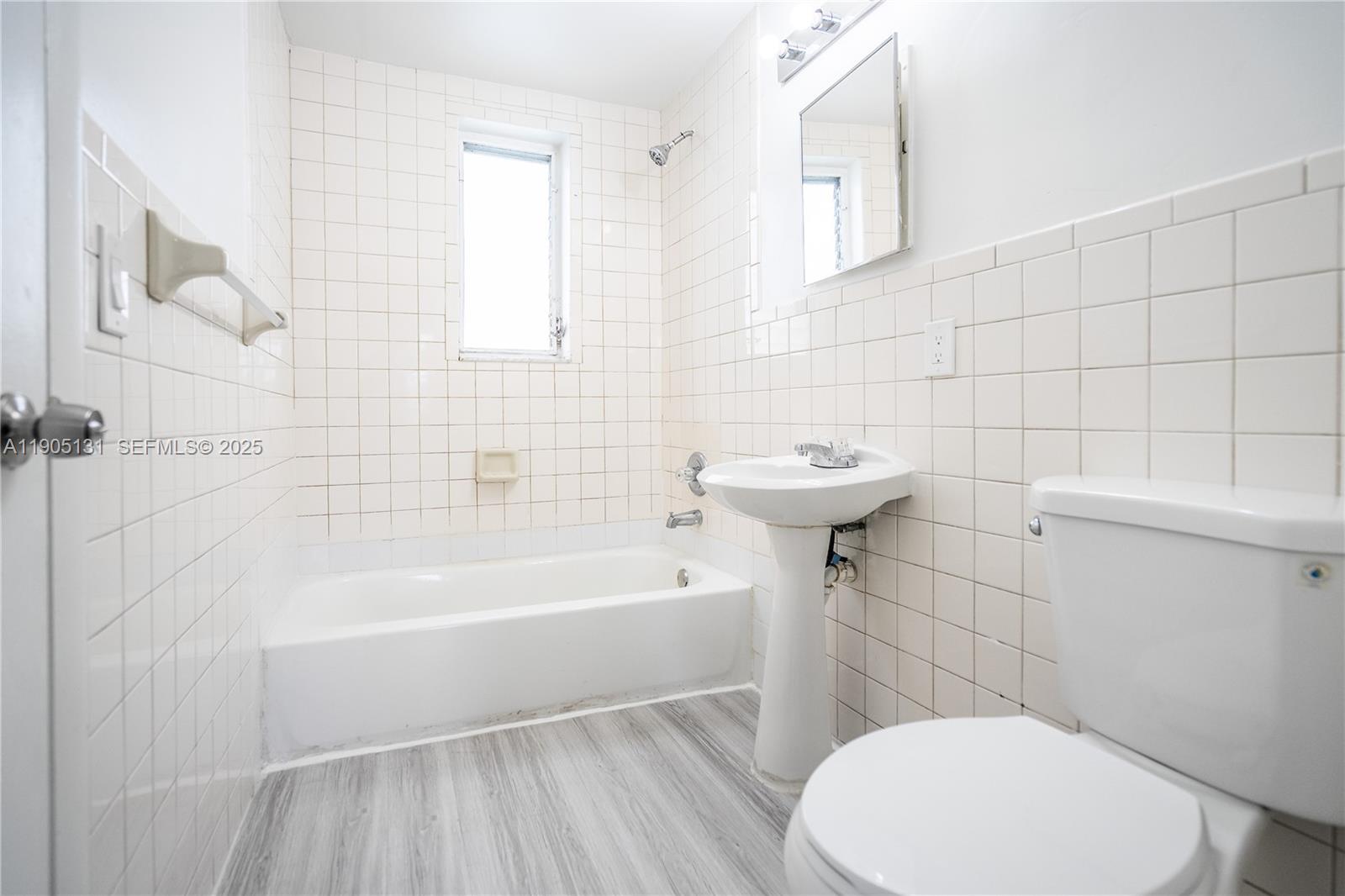 1208 71st Street, Unit 7 Miami Beach, FL 33141 - Photo 12 of 14 a bathroom with a sink a toilet and bathtub