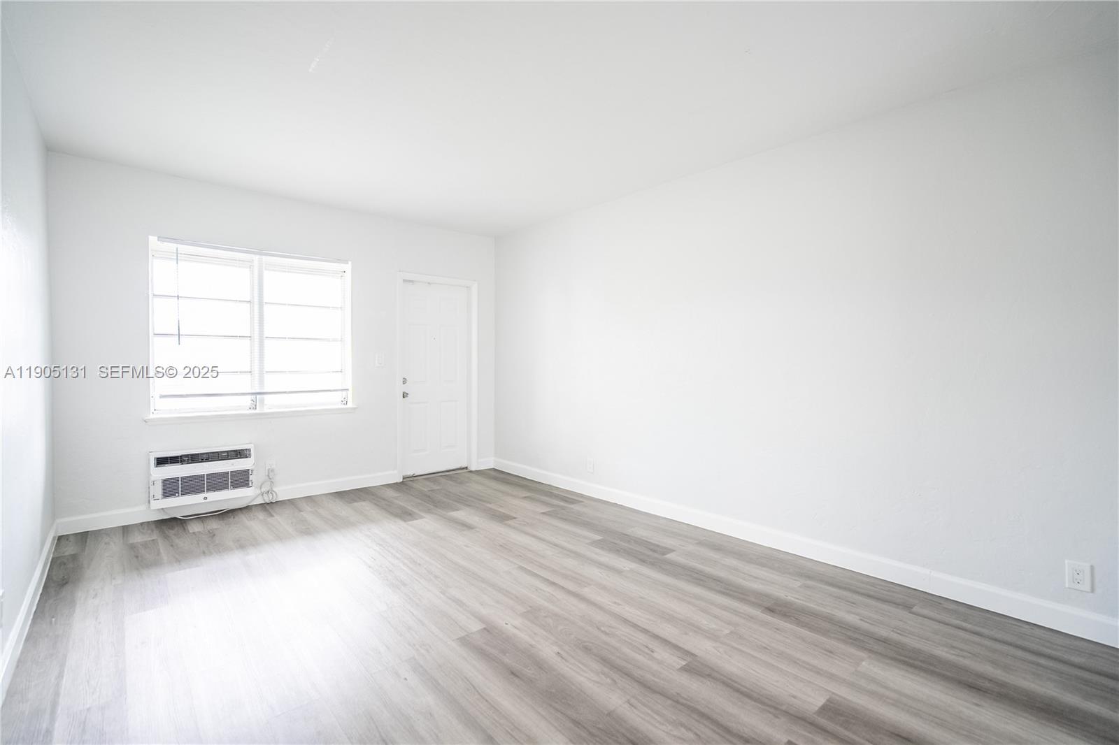 1208 71st Street, Unit 7 Miami Beach, FL 33141 - Photo 2 of 14 an empty room with windows