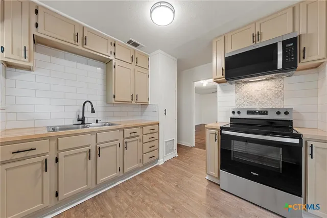 a kitchen with cabinets and a sink