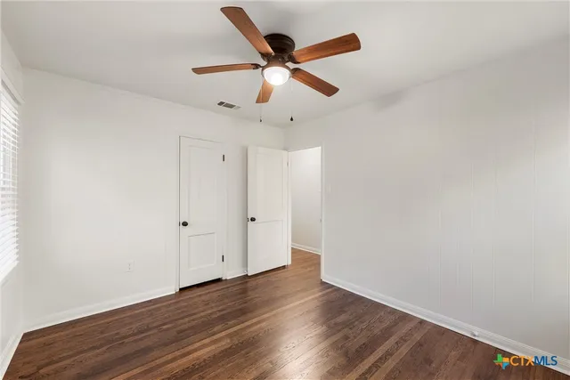 a bathroom with a sink a toilet a mirror a bathtub and shower