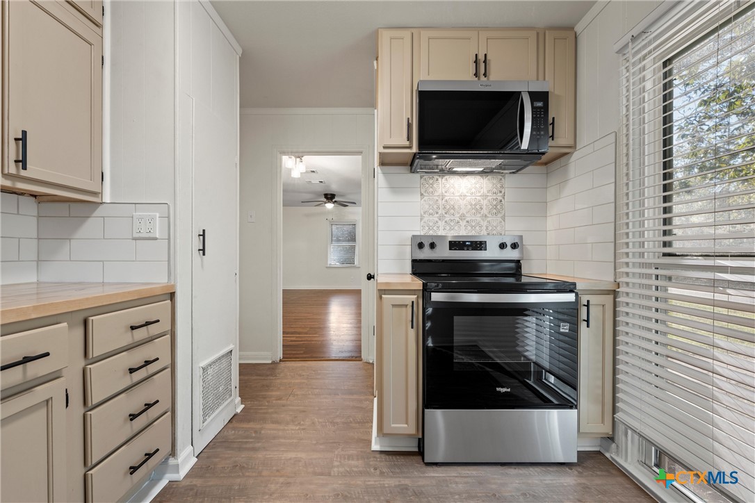 1203 South 5th Street Temple, TX 76504 - Photo 6 of 18 a kitchen with a stove and a microwave