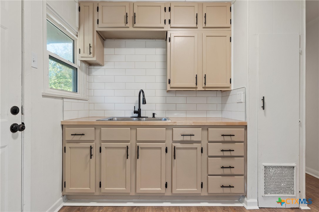 1203 South 5th Street Temple, TX 76504 - Photo 10 of 20 a kitchen with cabinets and a sink