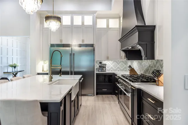 a kitchen with kitchen island stainless steel appliances a sink stove and refrigerator