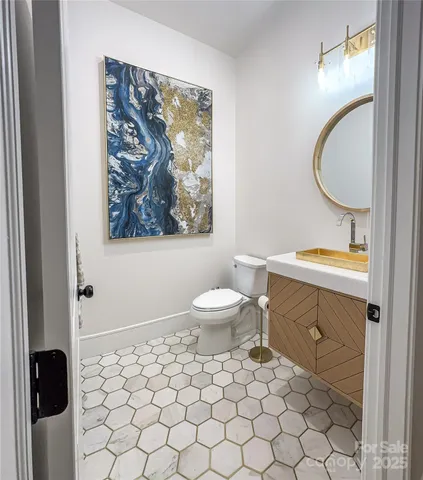 a bathroom with a toilet a sink and a mirror