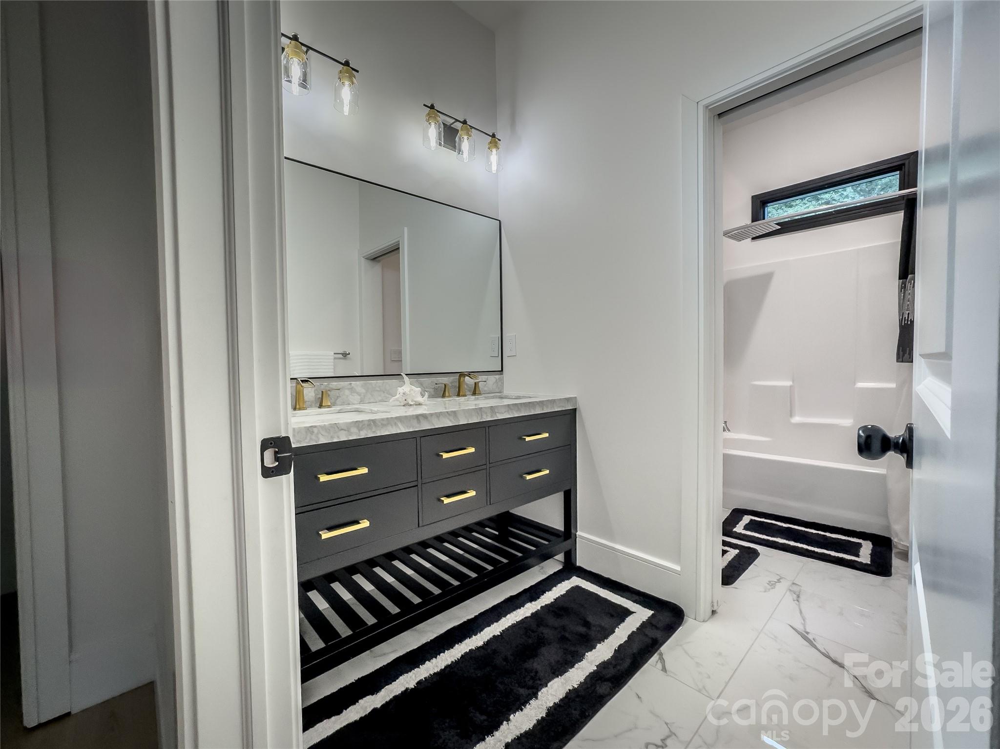 668 Players Ridge Road Hickory, NC 28601 - Photo 25 of 48 a bathroom with a sink a mirror and a shower