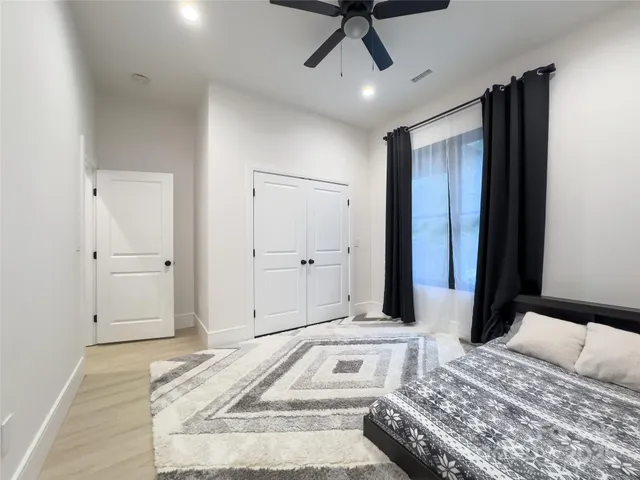 a bedroom with furniture and a window