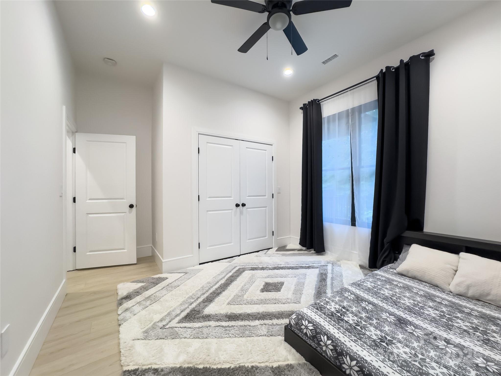 668 Players Ridge Road Hickory, NC 28601 - Photo 28 of 48 a bedroom with a bed and a chandelier