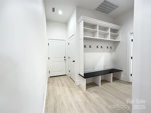 a view of washer and dryer with kitchen in the background