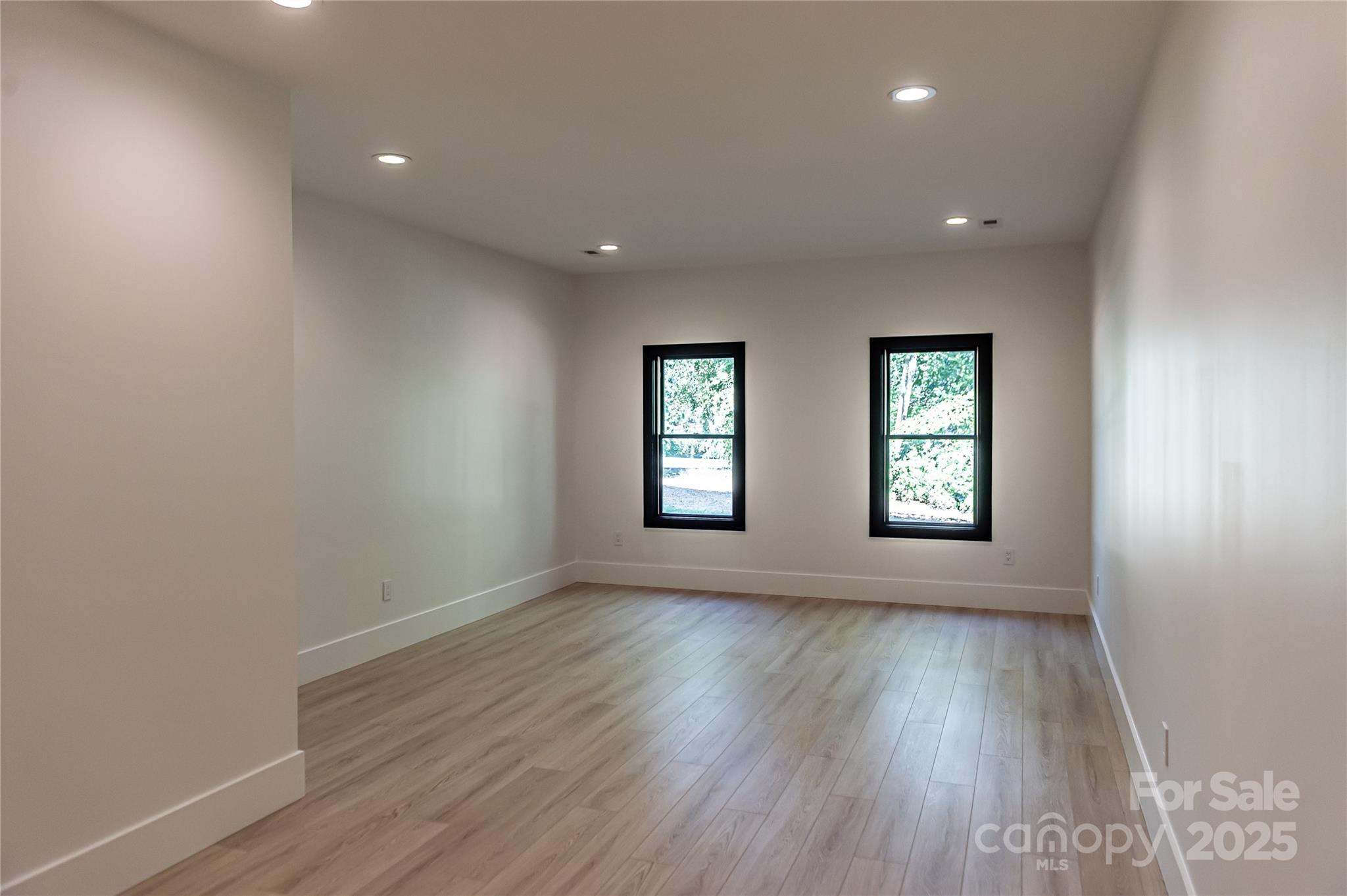 668 Players Ridge Road Hickory, NC 28601 - Photo 37 of 48 an empty room with wooden floor and windows