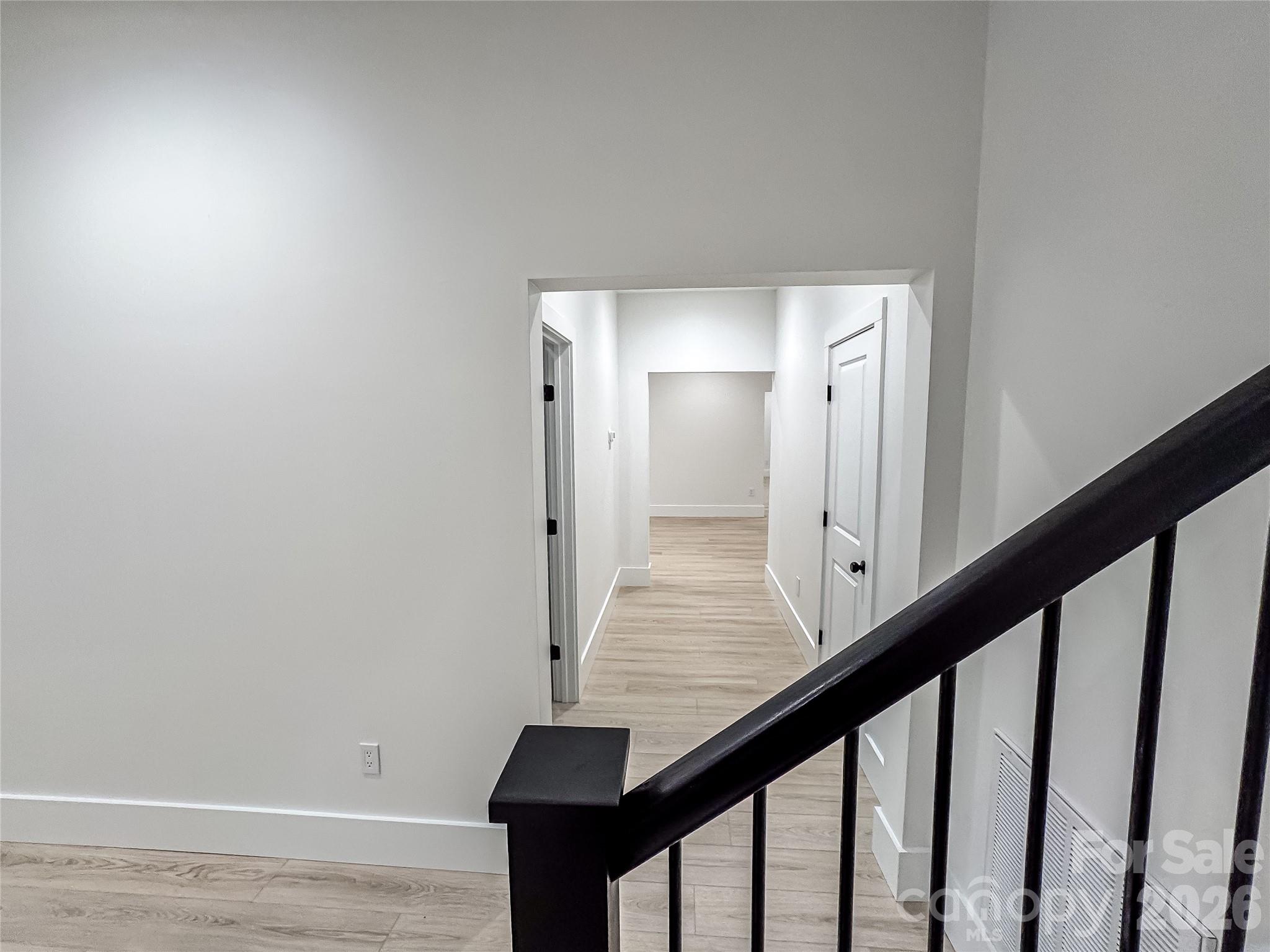 668 Players Ridge Road Hickory, NC 28601 - Photo 38 of 48 a view of a hallway with wooden floor and staircase