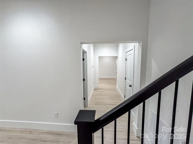an empty room with wooden floor and window